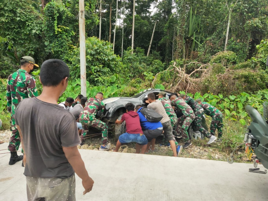 Satgas Pamtas Yonif 131/Brs Evakuasi Mobil Warga Yang Terguling